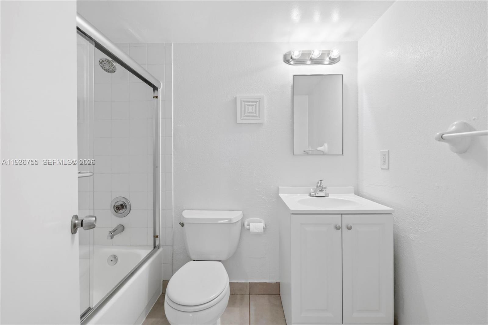 1405 Miami Road, Unit 10 Fort Lauderdale, FL 33316 - Photo 8 of 14 a bathroom with a toilet a sink and mirror