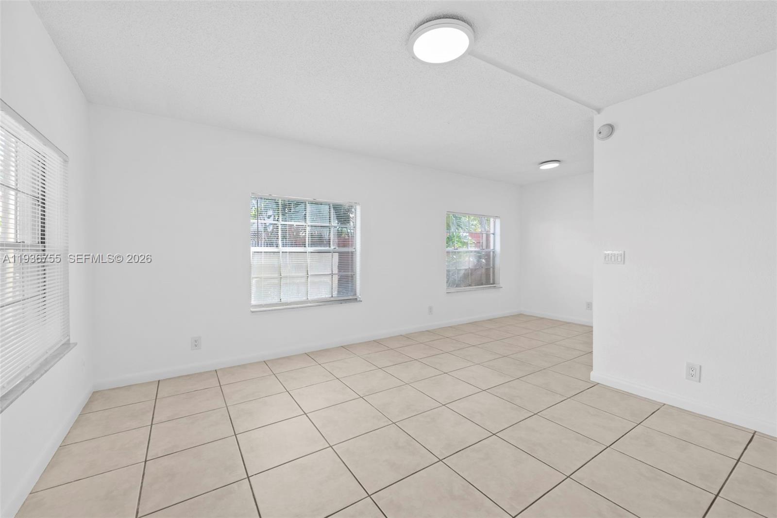 1405 Miami Road, Unit 10 Fort Lauderdale, FL 33316 - Photo 10 of 14 an empty room with windows