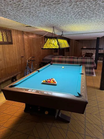 a room with furniture and pool view