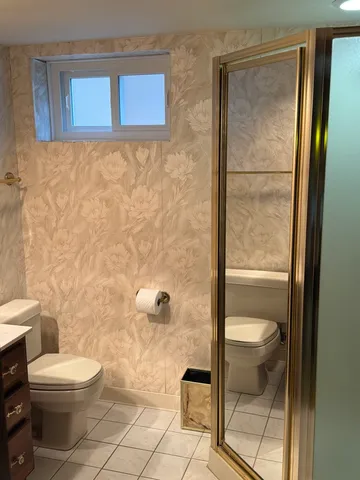 a bathroom with a toilet and a shower