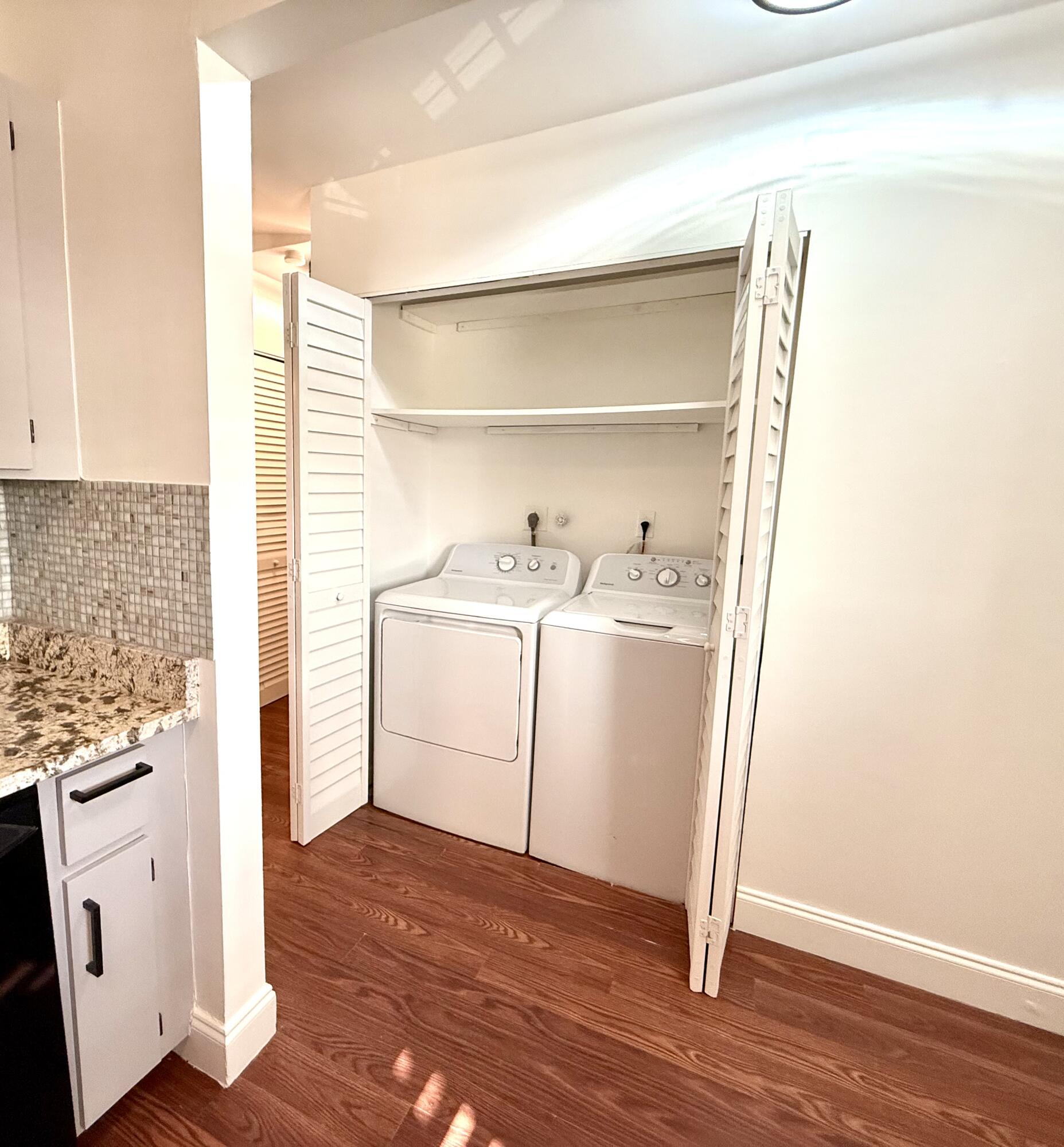 9503 Boca Cove Circle, Unit 610 Boca Raton, FL 33428 - Photo 14 of 16 a utility room with cabinets washer and dryer
