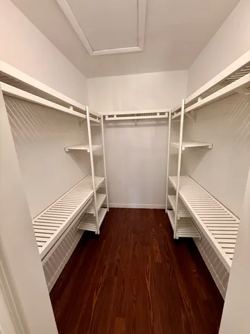 a view of walk in closet with empty racks