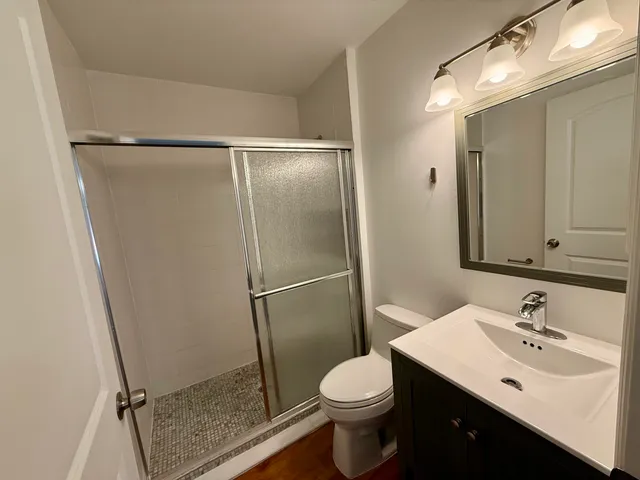 a bathroom with a sink toilet and shower