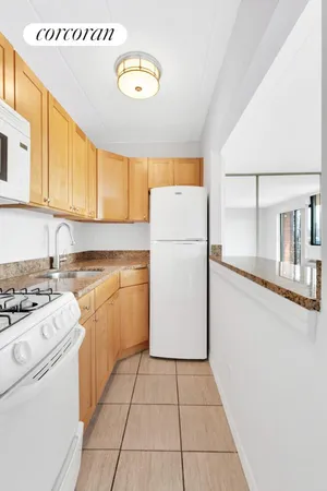 a kitchen with a refrigerator sink stove and cabinets