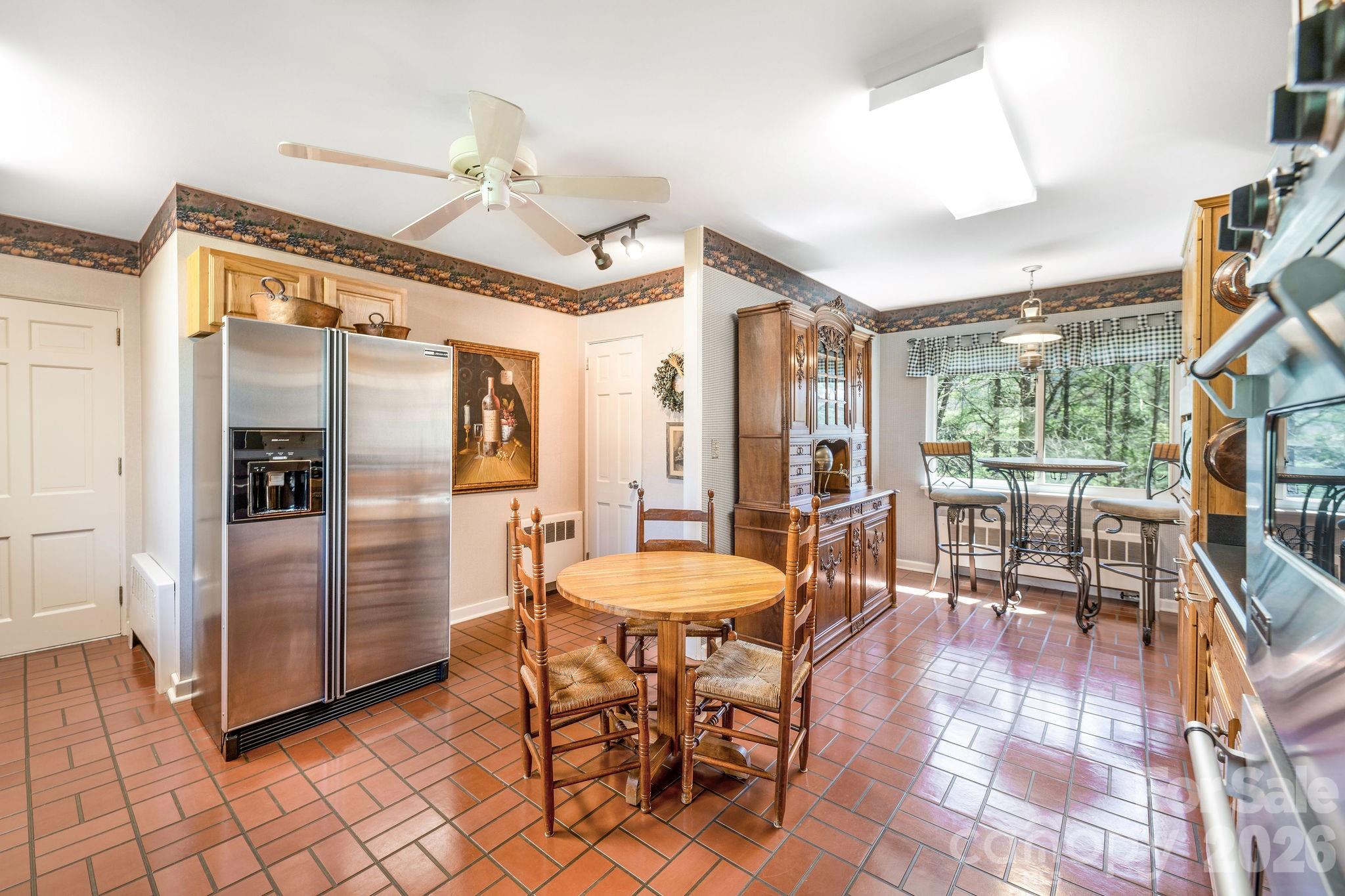 4 Dogwood Road Asheville, NC 28804 - Photo 21 of 48 a dining room with furniture and a floor to ceiling window