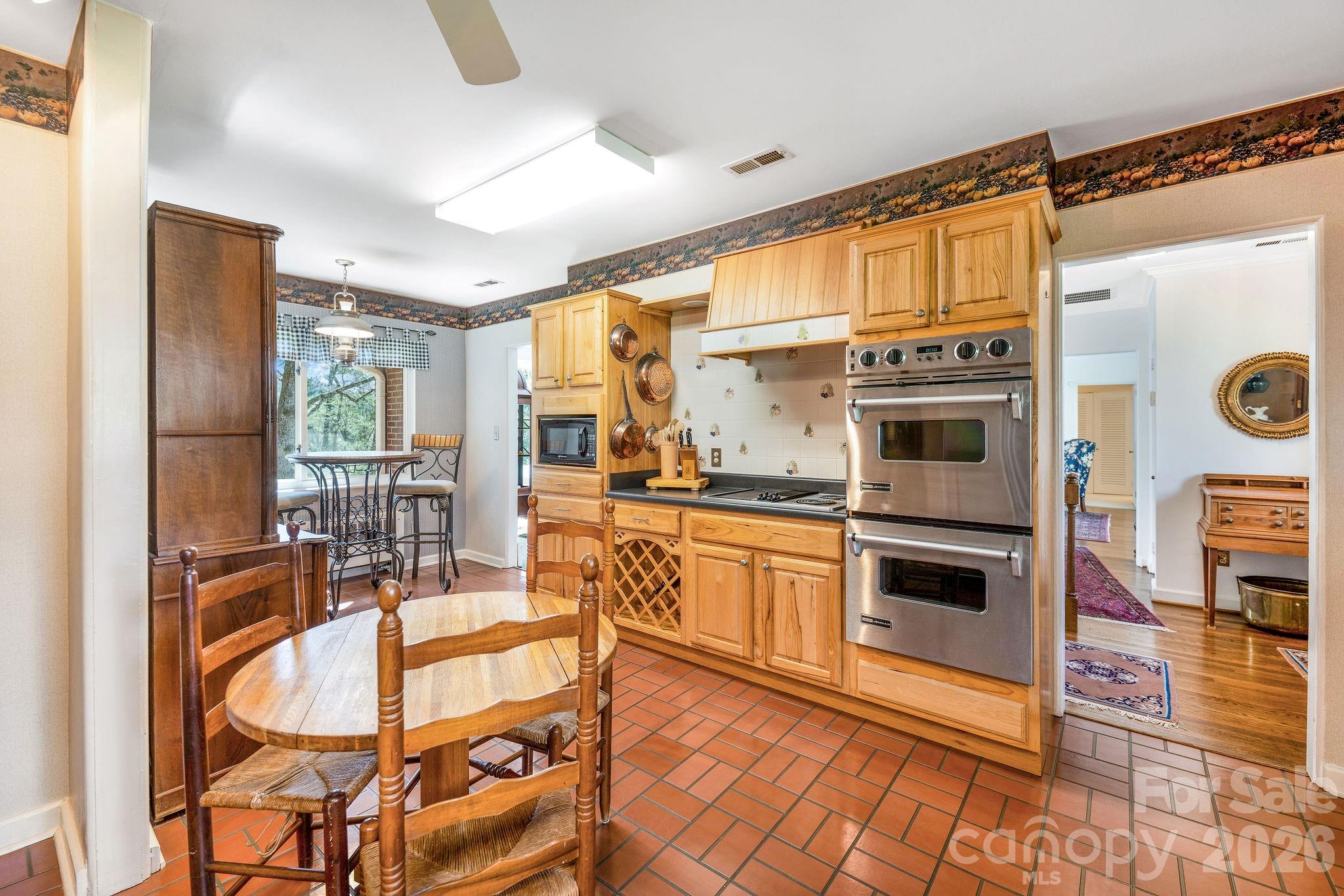 4 Dogwood Road Asheville, NC 28804 - Photo 22 of 48 a kitchen with stainless steel appliances kitchen island granite countertop a refrigerator and microwave