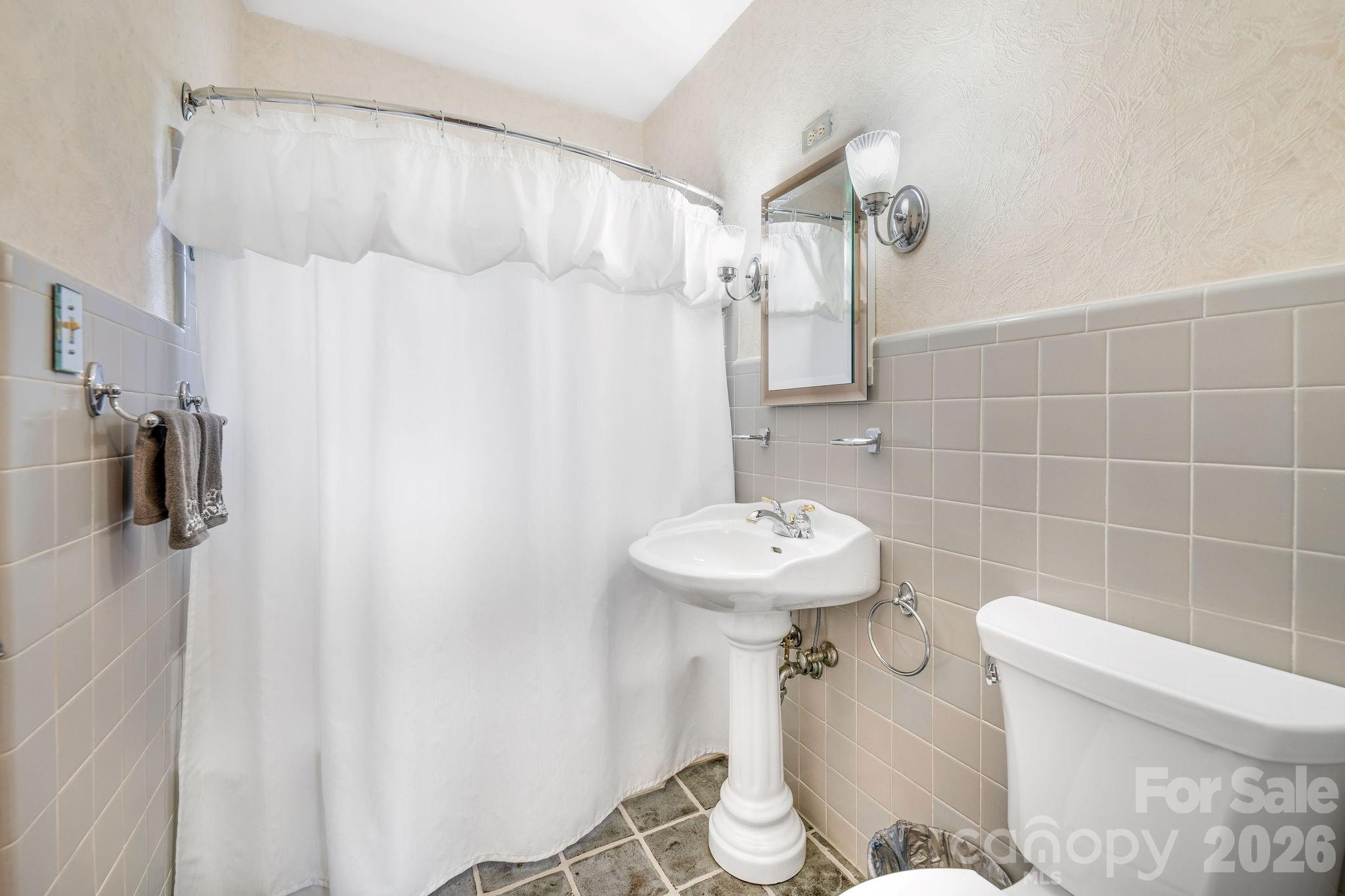 4 Dogwood Road Asheville, NC 28804 - Photo 26 of 48 a bathroom with a sink toilet and shower