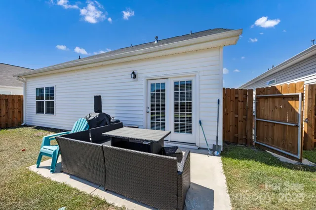 a view of a patio with couches chairs and potted plants