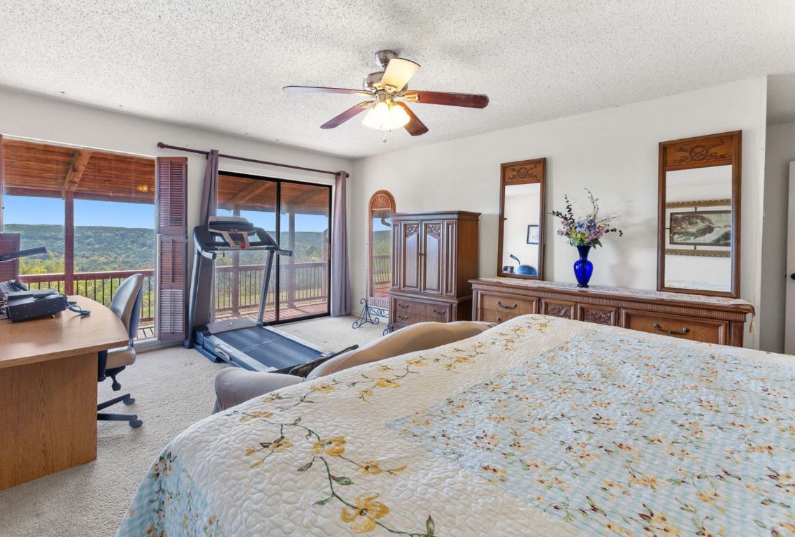 12516 Wire Road Leander, TX 78641 - Photo 16 of 40 a bedroom with a bed and a chandelier