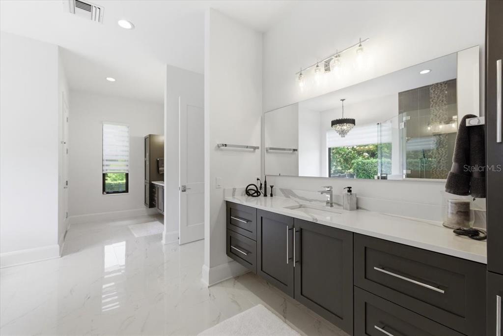 2829 Coastal Range Way Lutz, FL 33559 - Photo 37 of 64 a bathroom with a double vanity sink and a mirror