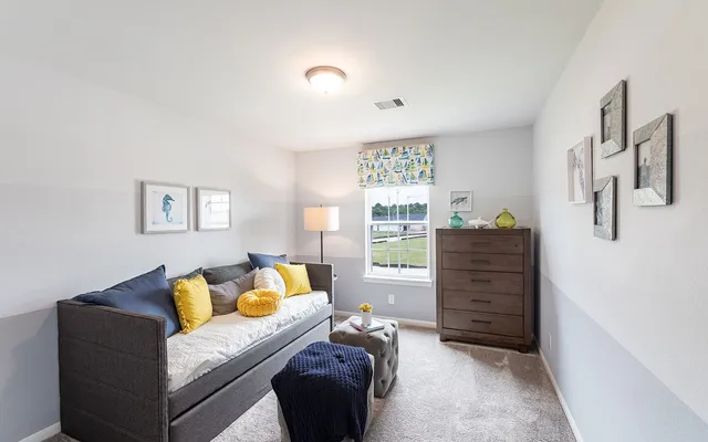 a bedroom with a bed and a potted plant