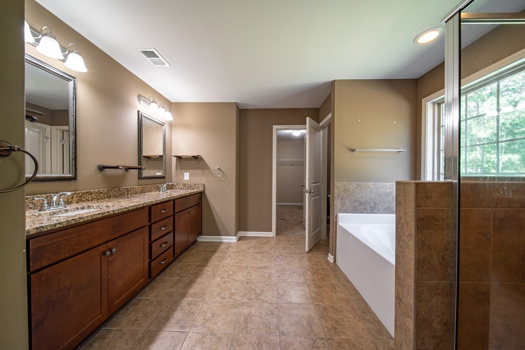 38 Pin Oak Way Hamilton, GA 31811 - Photo 40 of 50 a bathroom with a double vanity sink and a mirror