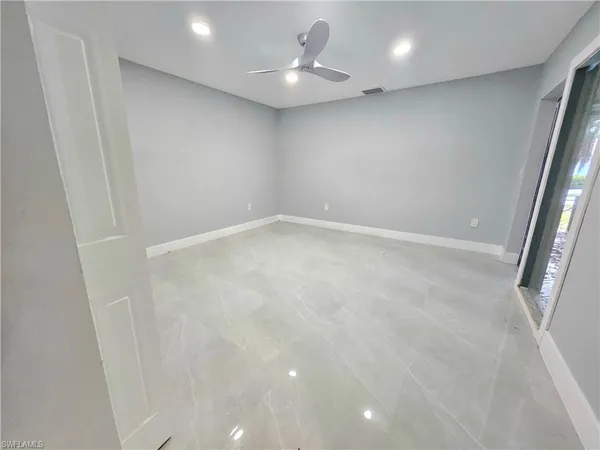 a bathroom with a granite countertop sink a toilet and shower