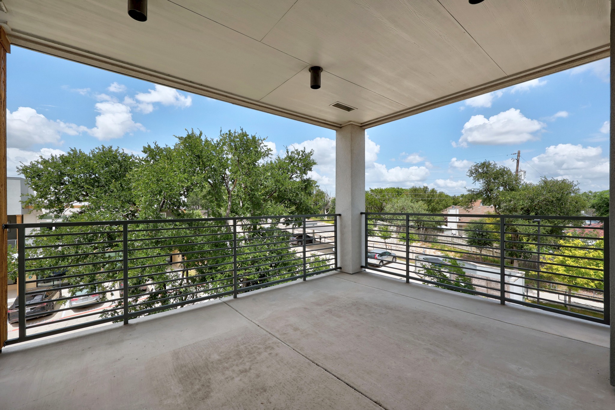 4801 Springdale Road, Unit 2301 Austin, TX 78723 - Photo 22 of 36 A spacious balcony offers elevated outdoor living with an open neighborhood outlook.