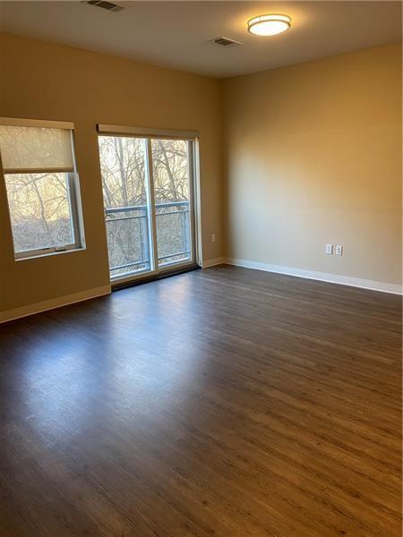 1655 Fifth Avenue, Unit 605 Pittsburgh, PA 15219 - Photo 18 of 19 an empty room with wooden floor and windows