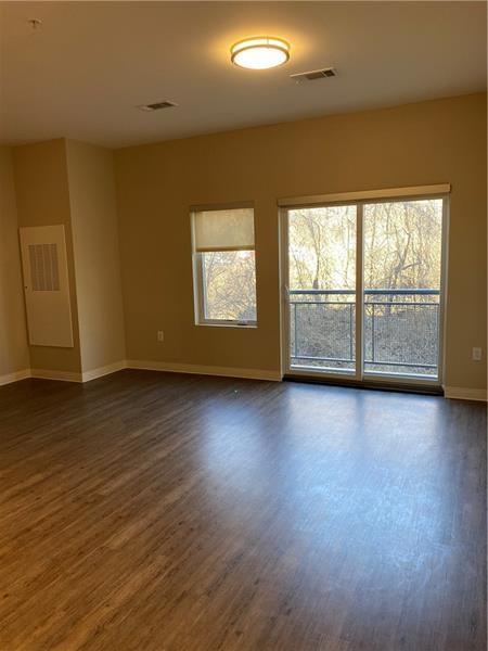 1655 Fifth Avenue, Unit 605 Pittsburgh, PA 15219 - Photo 19 of 19 an empty room with wooden floor and windows