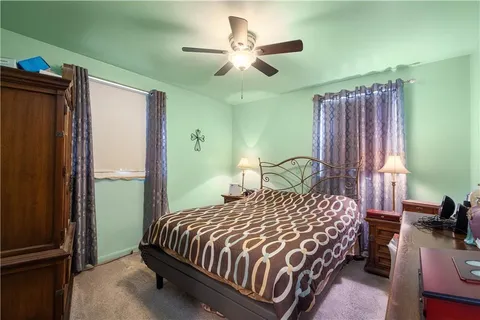 a bedroom with a bed dresser and a window