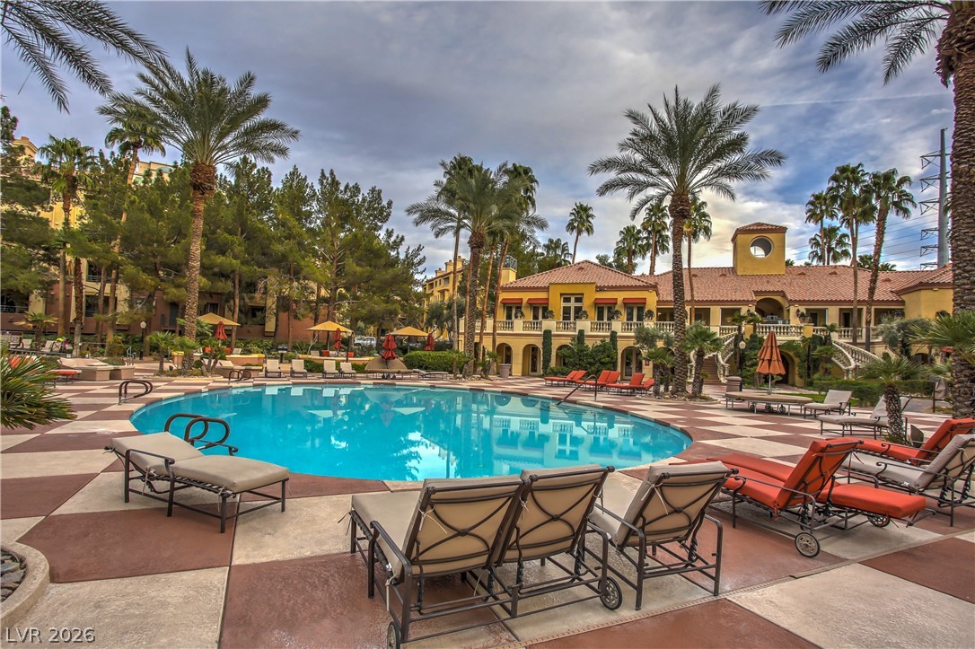 210 East Flamingo Road, Unit 208 Las Vegas, NV 89169 - Photo 2 of 42 A resort-style oasis offers a refreshing pool surrounded by lush landscaping and inviting lounging areas.