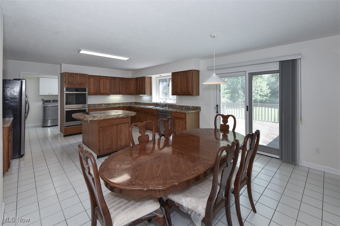 30776 Cedar Road Cleveland, OH 44124 - Photo 6 of 41 Dining area with light tile patterned floors and washer / dryer