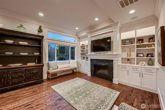 a living room with furniture a flat screen tv and a fireplace