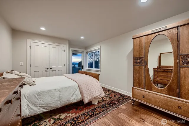 a bedroom with a bed and a mirror