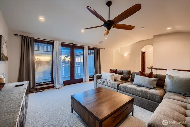 a living room with furniture and a ceiling fan