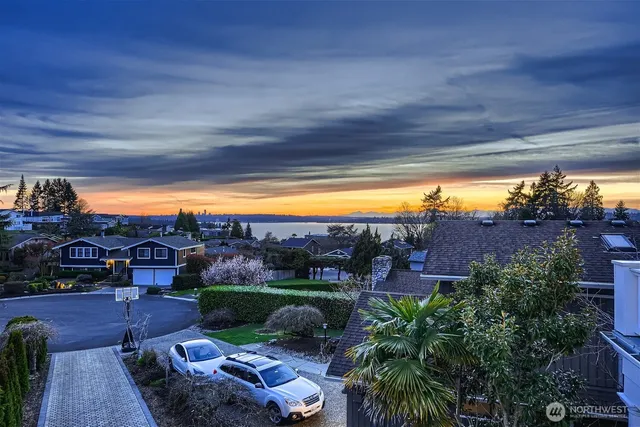 a view of a patio with couches and table and chairs under an umbrella