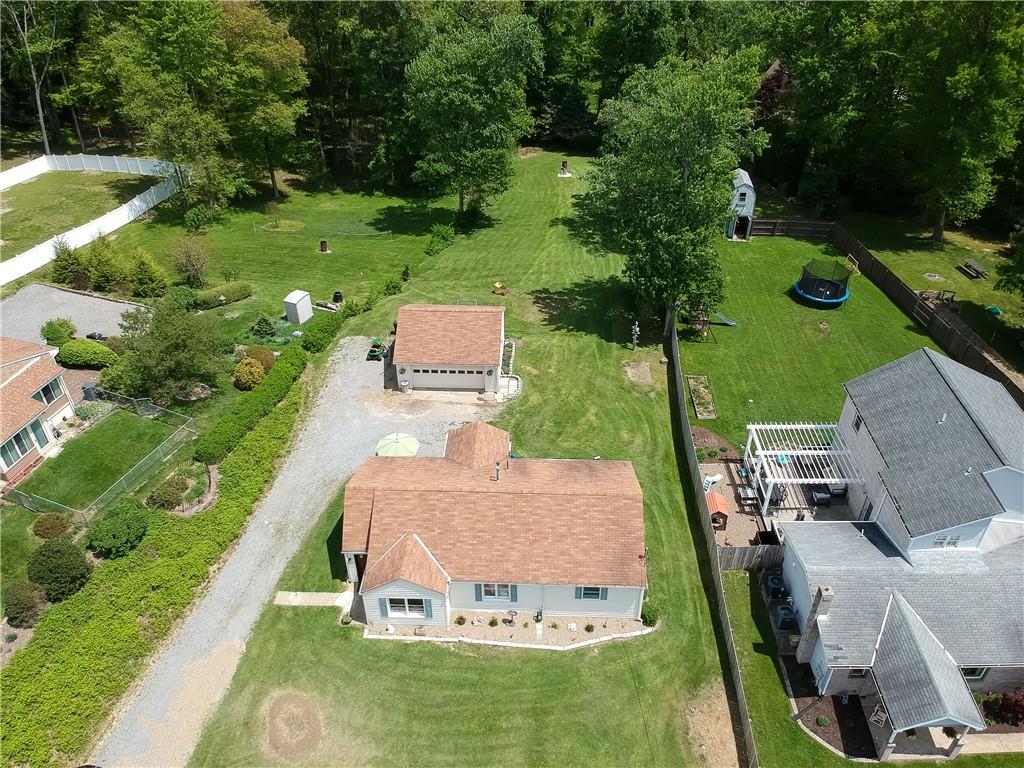 119 Lovi Road Baden, PA 15005 - Photo 27 of 41 a view of a backyard with table and chairs potted plants and large trees