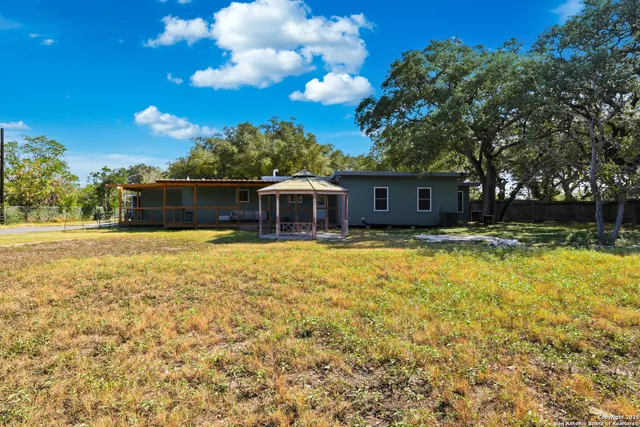 a front view of house with yard and swimming pool