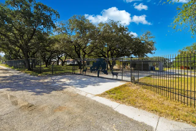 a view of a swimming pool with a bench and trees around