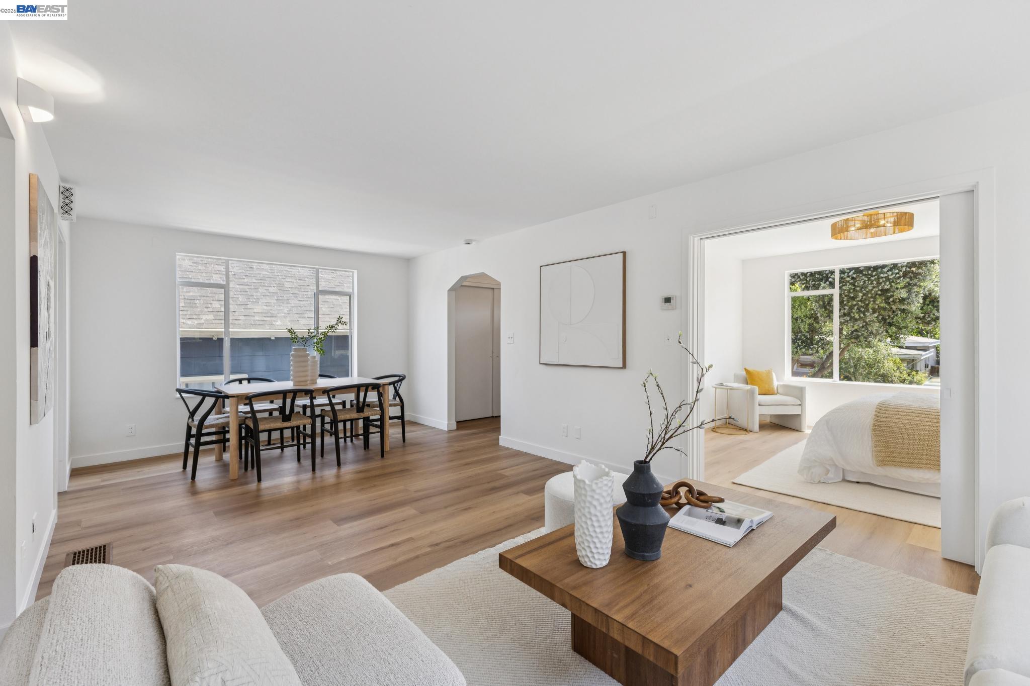 1219 Pearl Street Alameda, CA 94501 - Photo 11 of 40 a living room with furniture a table and kitchen view with wooden floor