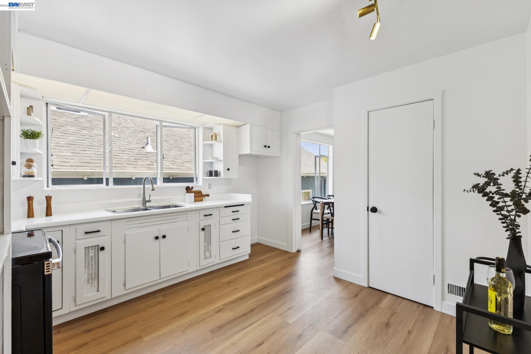 1219 Pearl Street Alameda, CA 94501 - Photo 20 of 40 a large kitchen with a lot of counter space and wooden floor