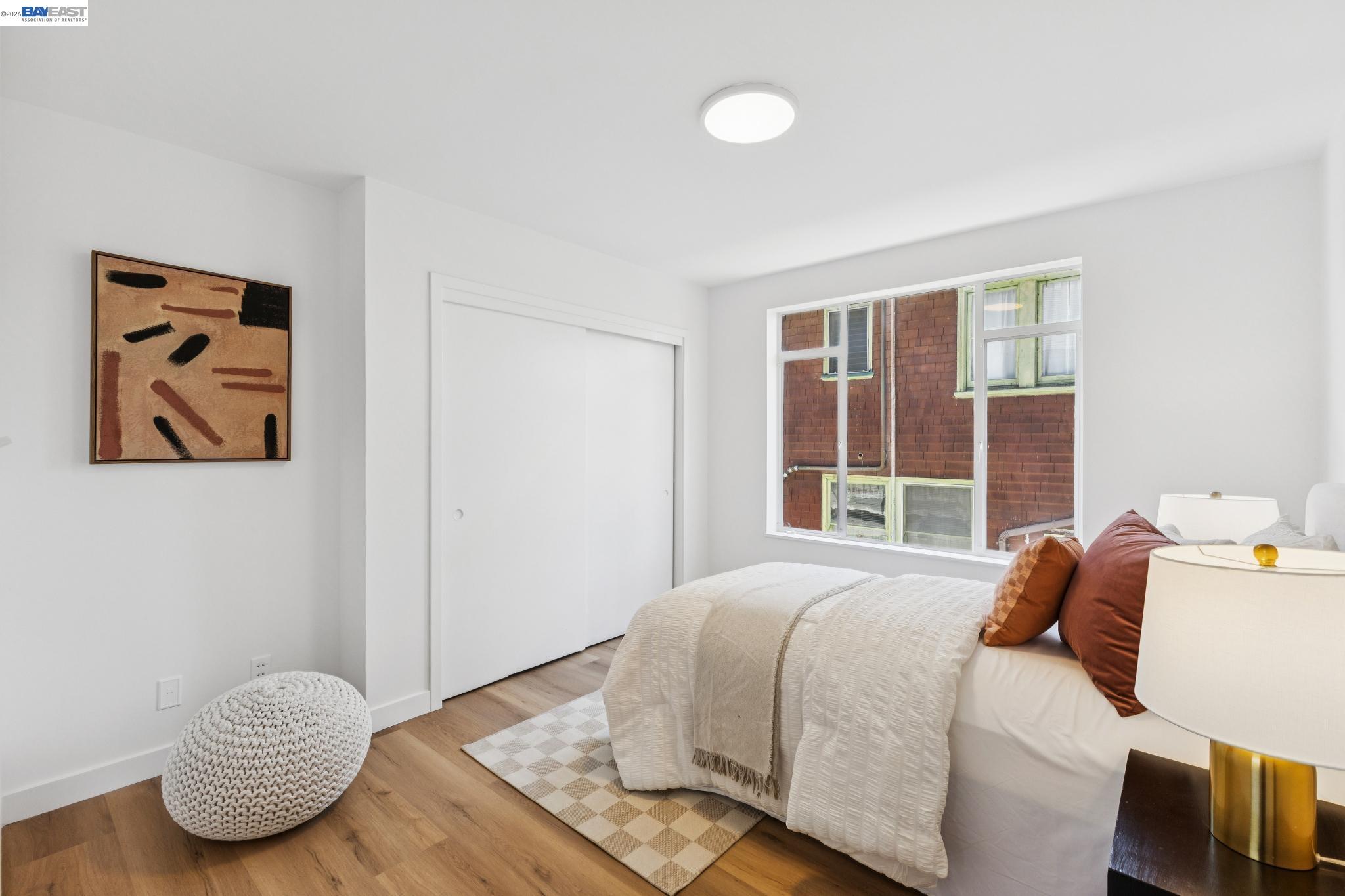 1219 Pearl Street Alameda, CA 94501 - Photo 21 of 40 a bedroom with a bed and wooden floor