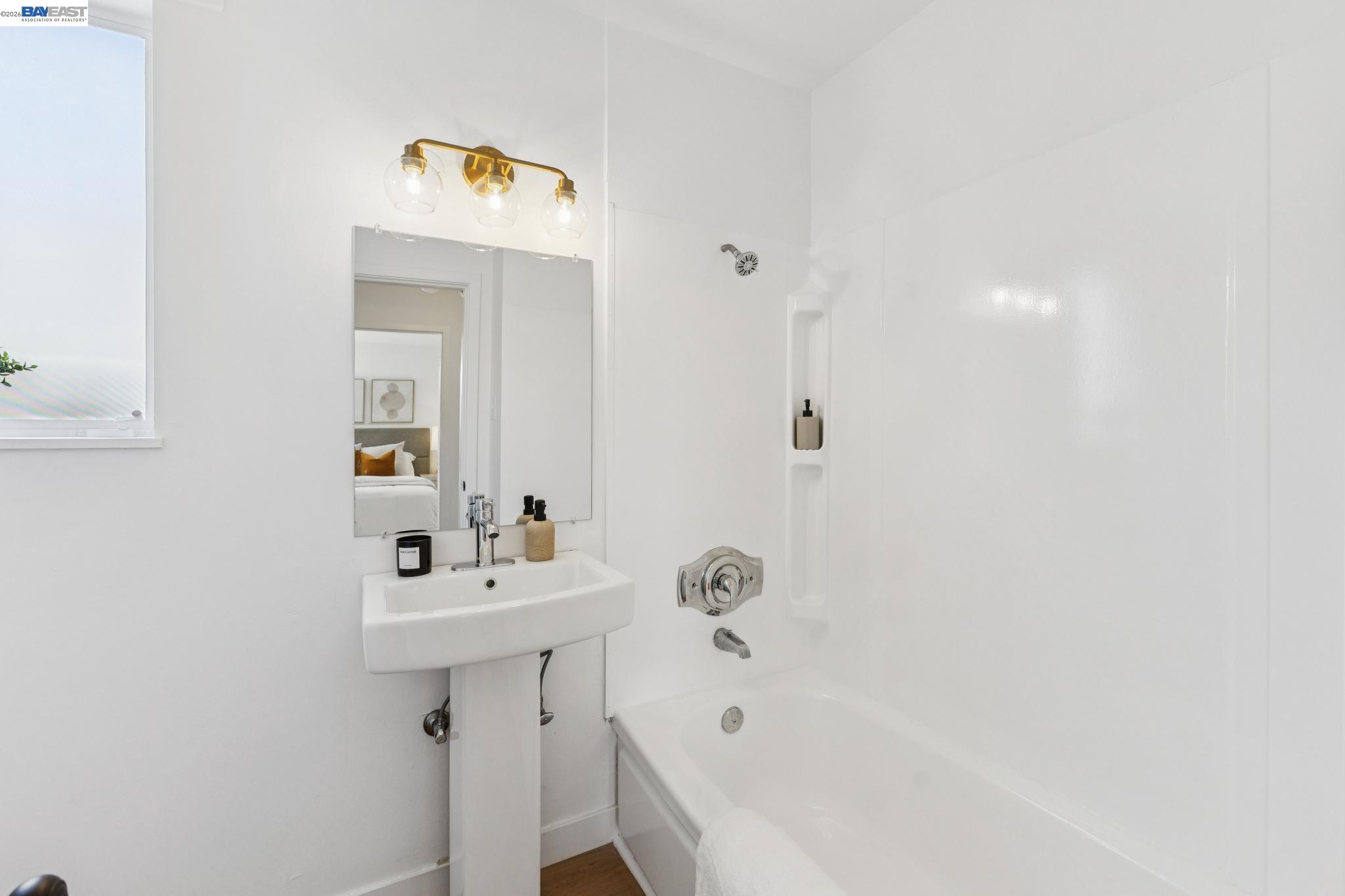 1219 Pearl Street Alameda, CA 94501 - Photo 23 of 40 a bathroom with a sink a mirror and a bathtub