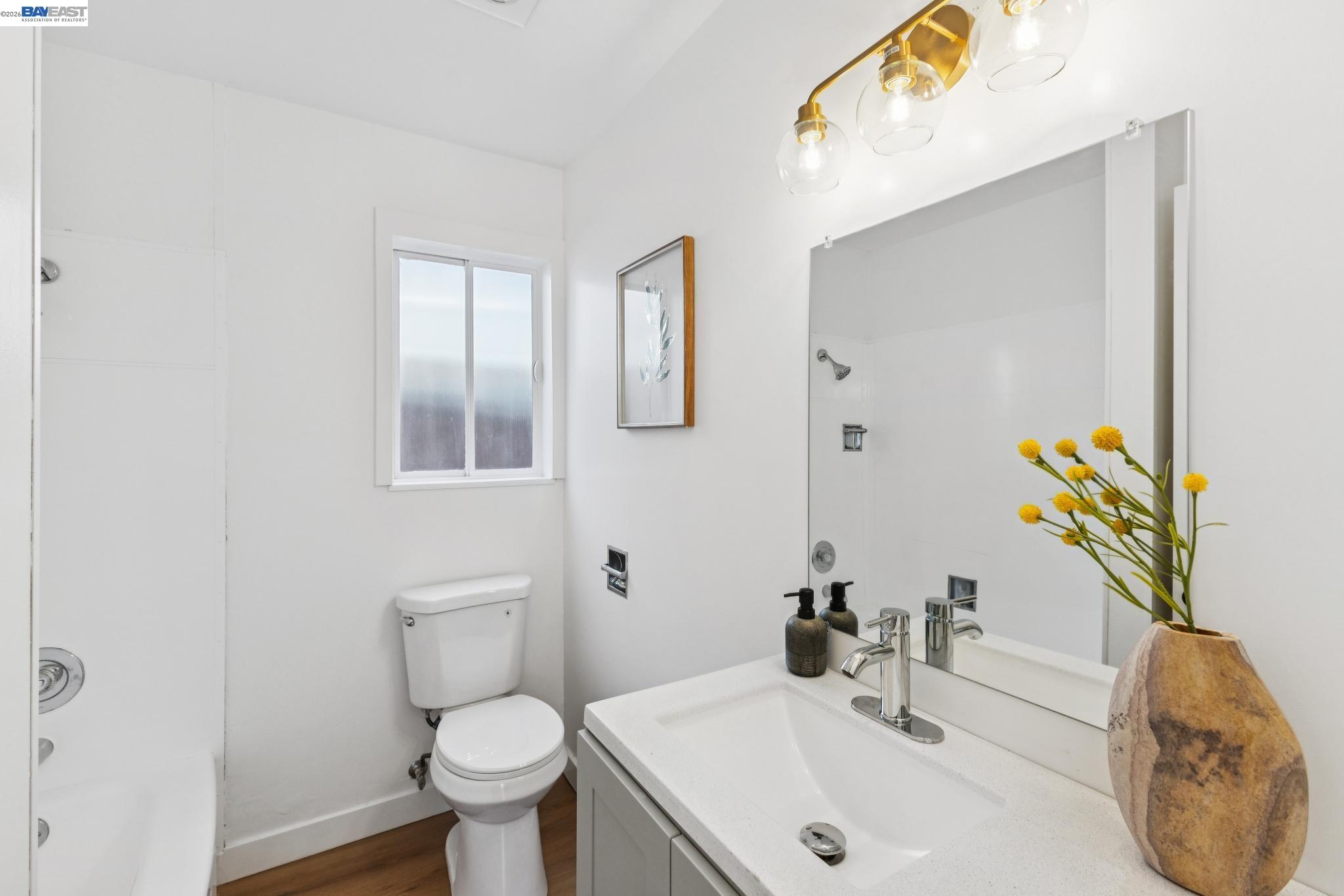 1219 Pearl Street Alameda, CA 94501 - Photo 32 of 40 a bathroom with a sink a toilet and a mirror