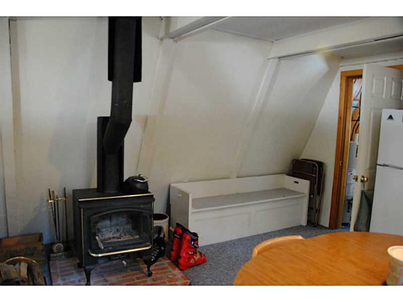 1008 Round House Road Carrabassett Valley, ME 04947 - Photo 8 of 27 Other. Woodstove in Living Area.