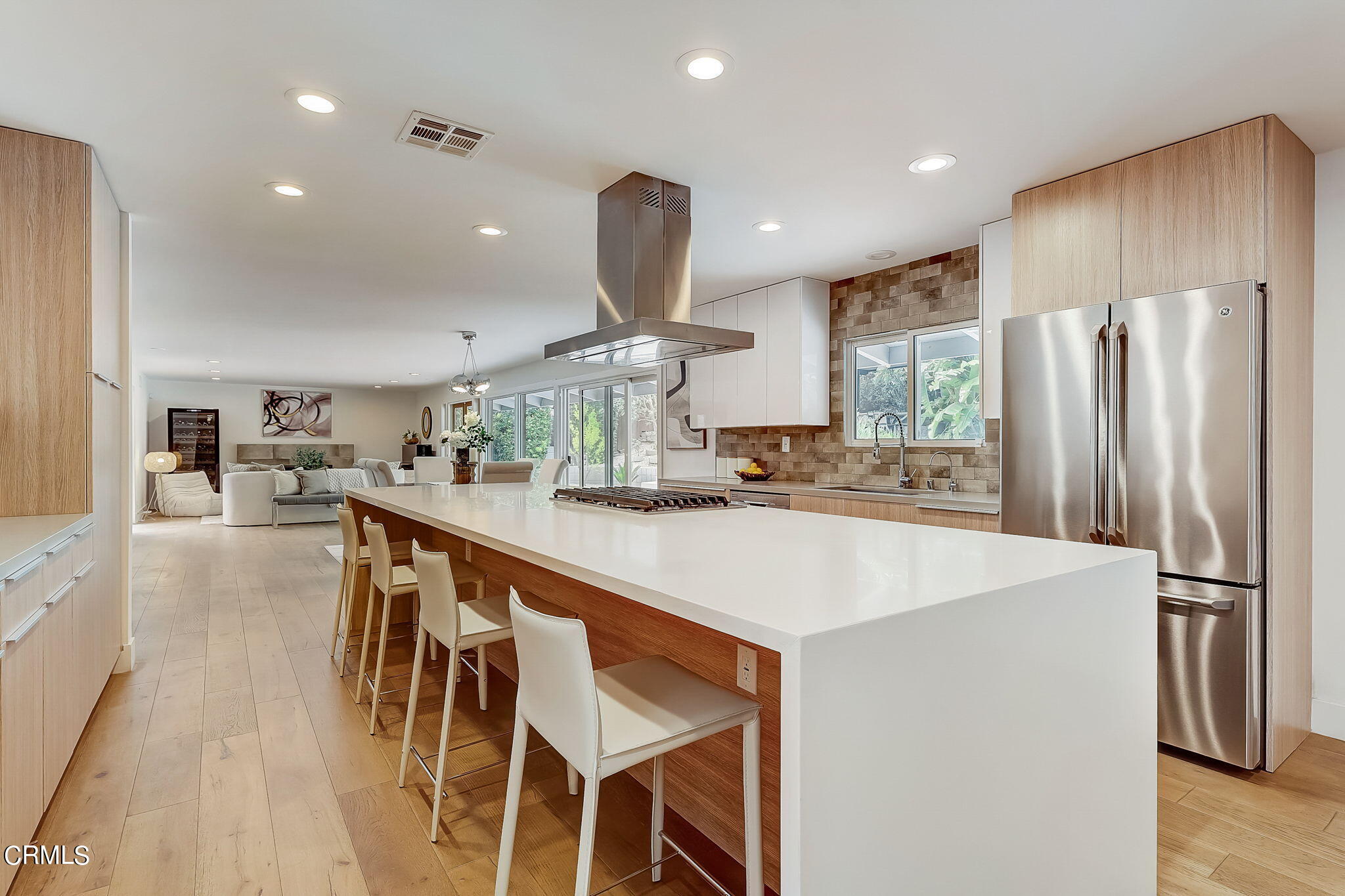 3785 Ranch Top Road Pasadena, CA 91107 - Photo 10 of 39 a kitchen with stainless steel appliances kitchen island granite countertop a refrigerator a stove a sink a dining table and chairs with wooden floor
