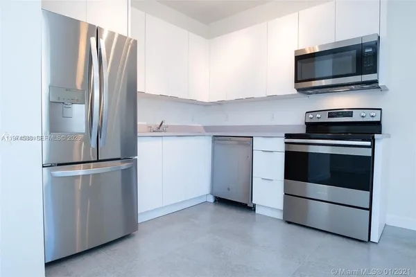 a kitchen with a refrigerator stove and microwave