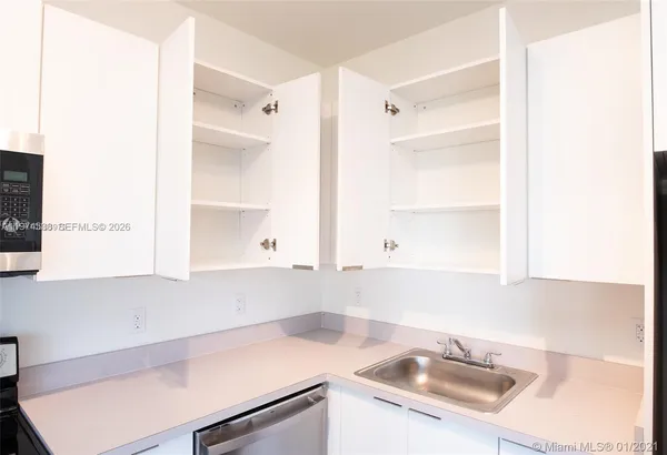 a view of a sink and a window in a kitchen