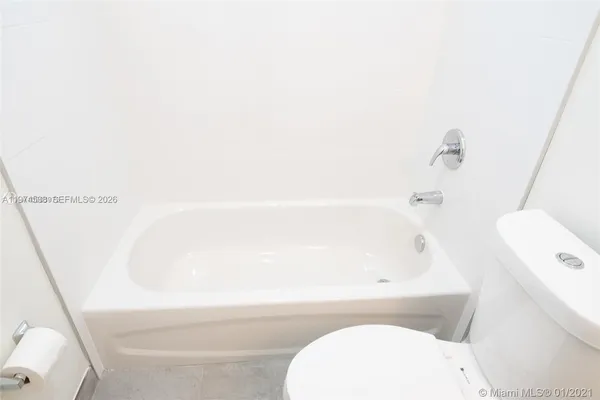 a bathroom with a bathtub and toilet