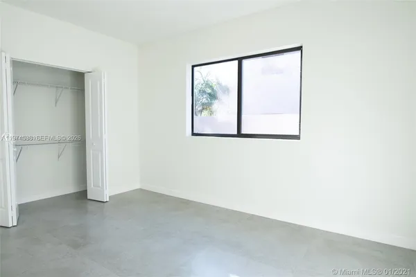 a view of a small space with wooden floor and a window