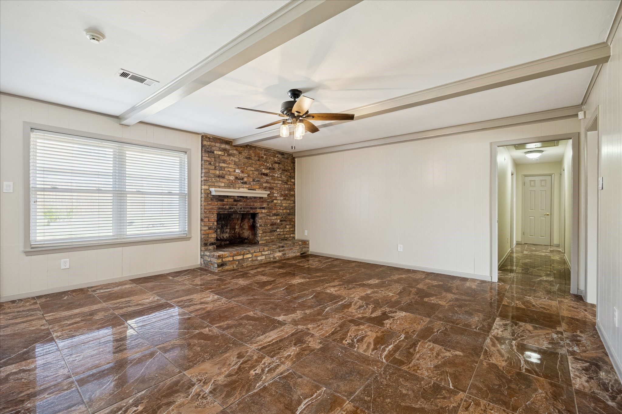 10718 Inwood Drive Houston, TX 77042 - Photo 11 of 20 Another view of the family room with windows overlooking the backyard, and a view down the hall to the bedrooms.