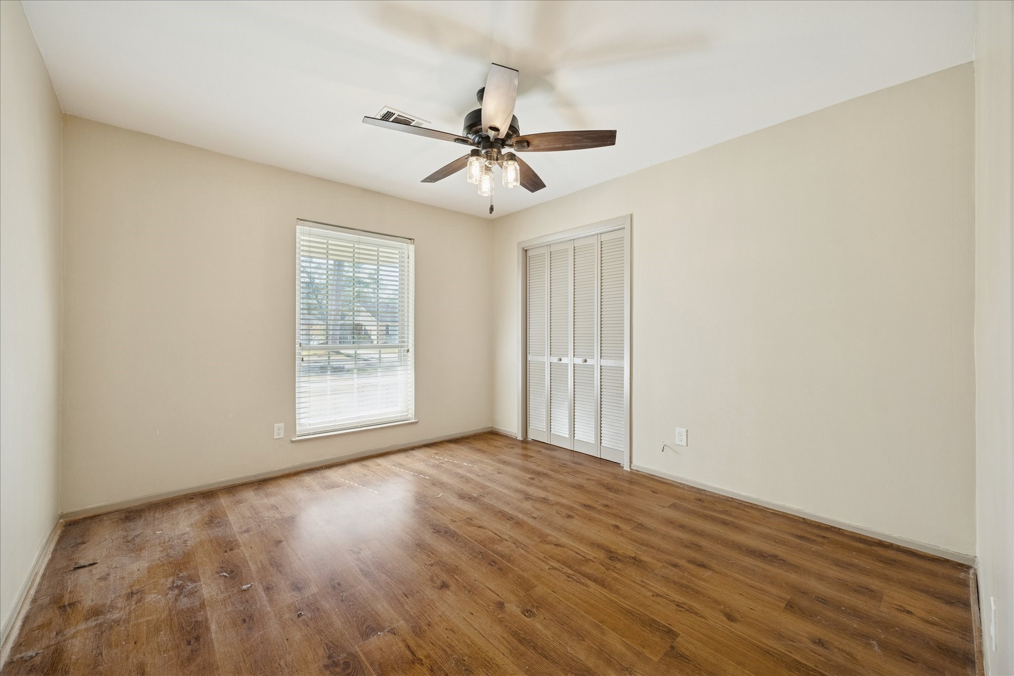 10718 Inwood Drive Houston, TX 77042 - Photo 18 of 20 A secondary bedroom with a view to the front yard and plenty of closet space. Notice the lovely wood floors have been carried throughout all the bedrooms.