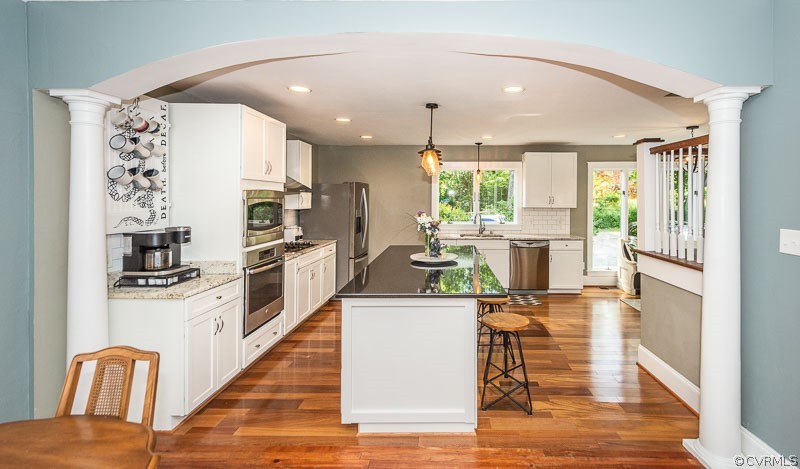 8088 Nelson Ridge Drive Hanover, VA 23069 - Photo 31 of 50 a kitchen with stainless steel appliances granite countertop a stove top oven a sink and a refrigerator