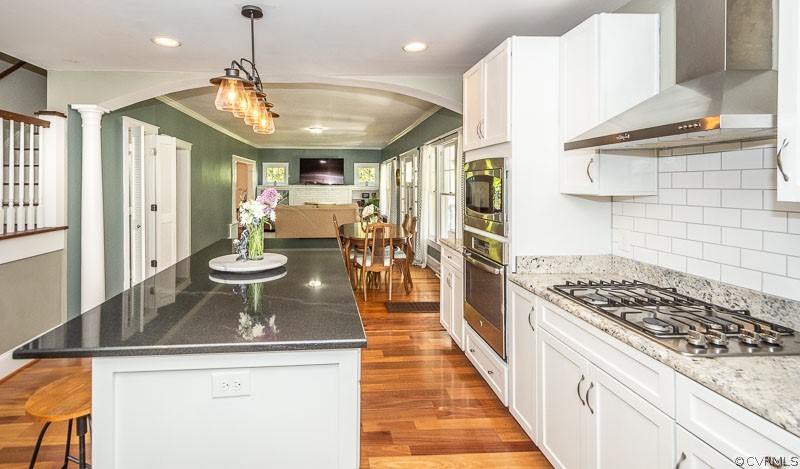 8088 Nelson Ridge Drive Hanover, VA 23069 - Photo 36 of 50 a kitchen with a sink a stove and chairs