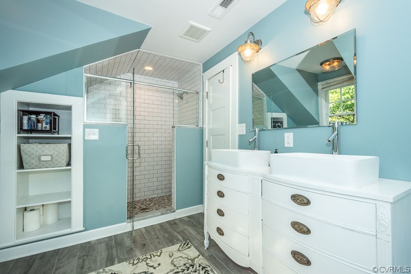 8088 Nelson Ridge Drive Hanover, VA 23069 - Photo 43 of 50 a bathroom with a sink a mirror and a shower