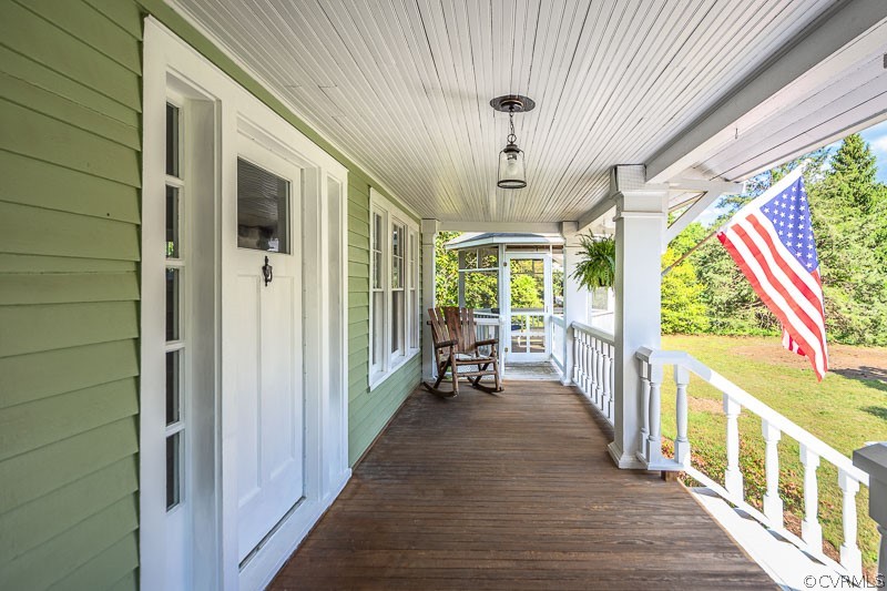 8088 Nelson Ridge Drive Hanover, VA 23069 - Photo 5 of 50 a view of a porch with wooden floor and furniture