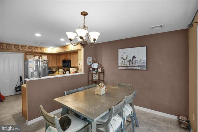a view of a dining room with furniture and chandelier