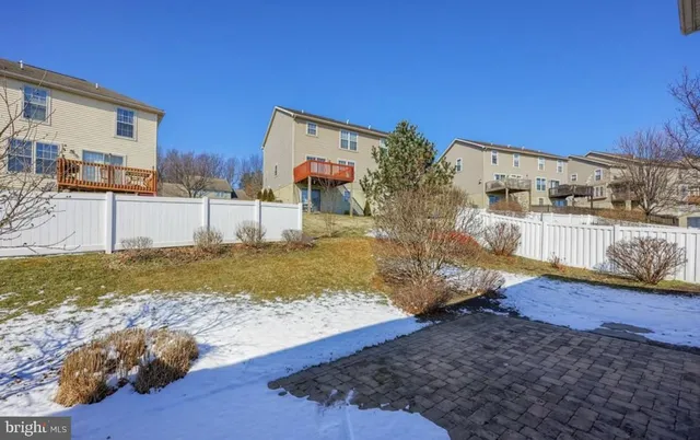 a view of a house with a yard covered in snow