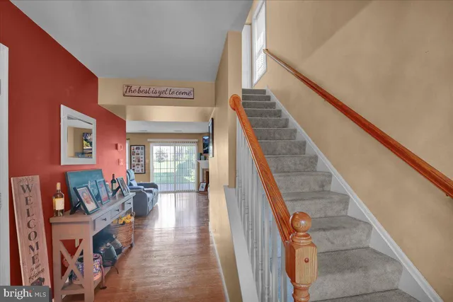 a view of an entryway with wooden floor and stairs